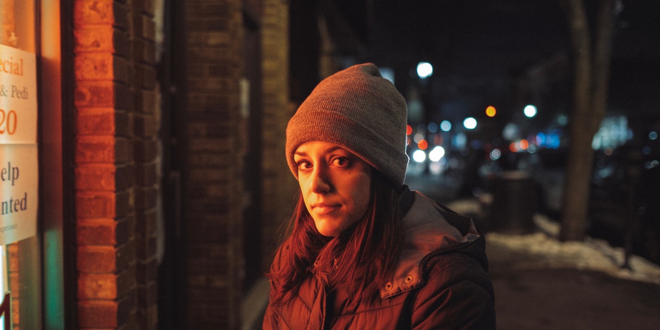 woman standing on street in the dark