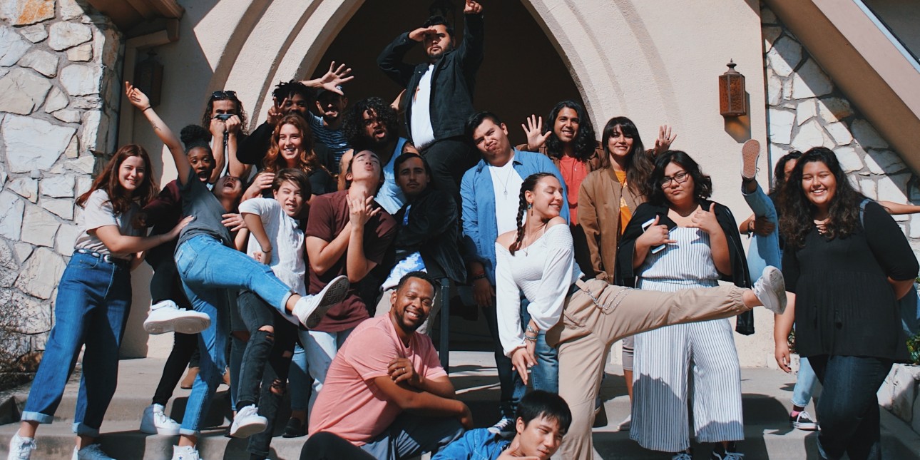 Young people posing in front of a building