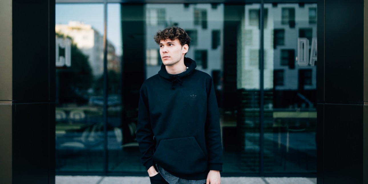 person standing by glass building