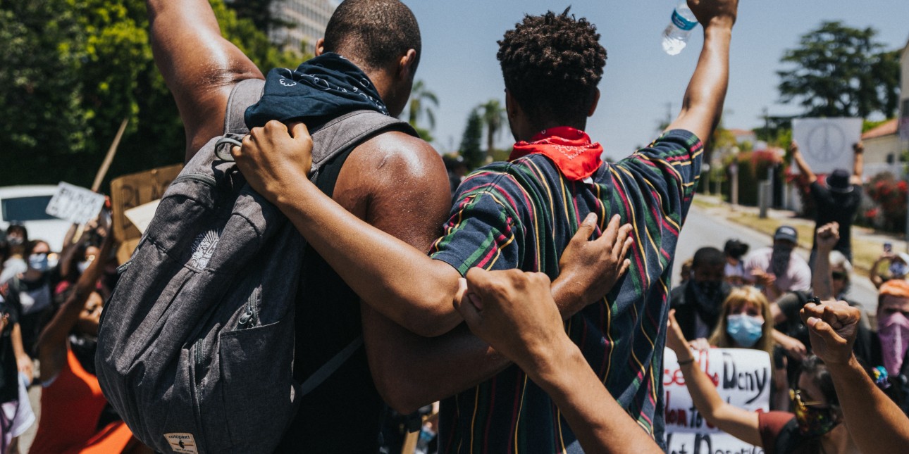 two men in solidarity at a protest