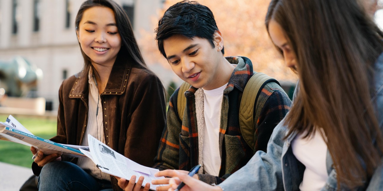 Teen young adults sitting outdoors together