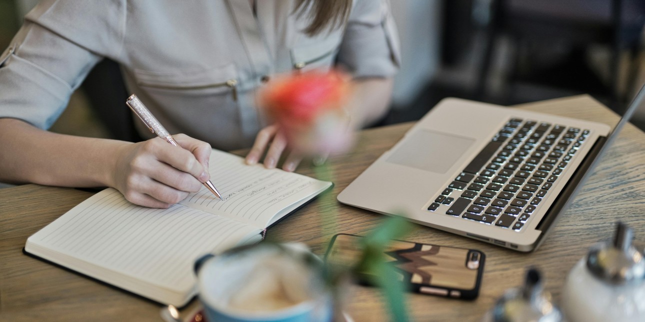 A woman taking notes from her laptop