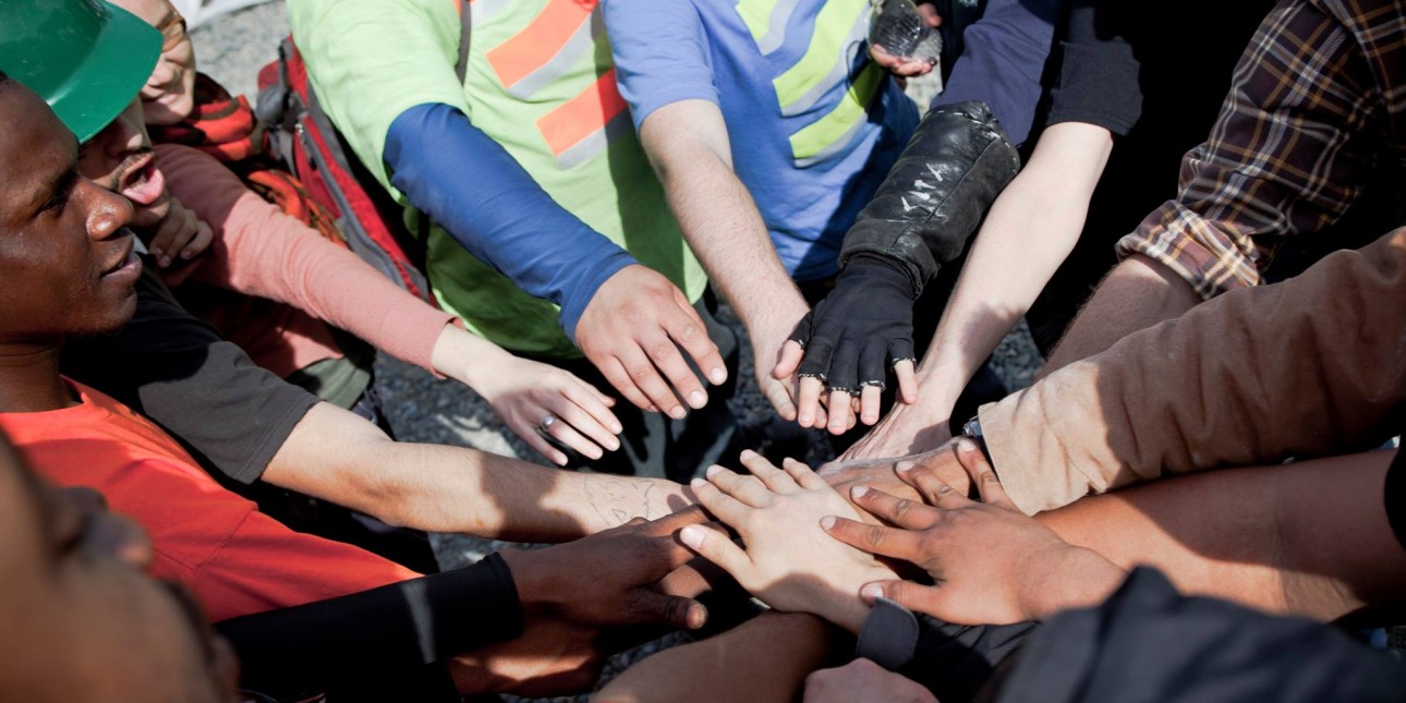 Group of people with their hands in the middle