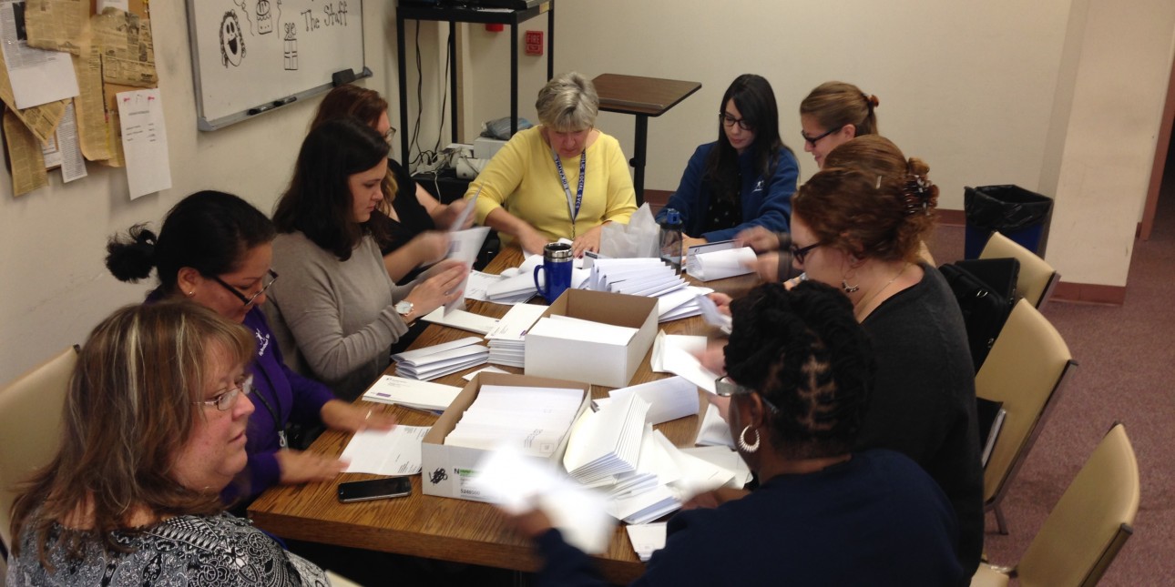 Group of people stuffing envelopes