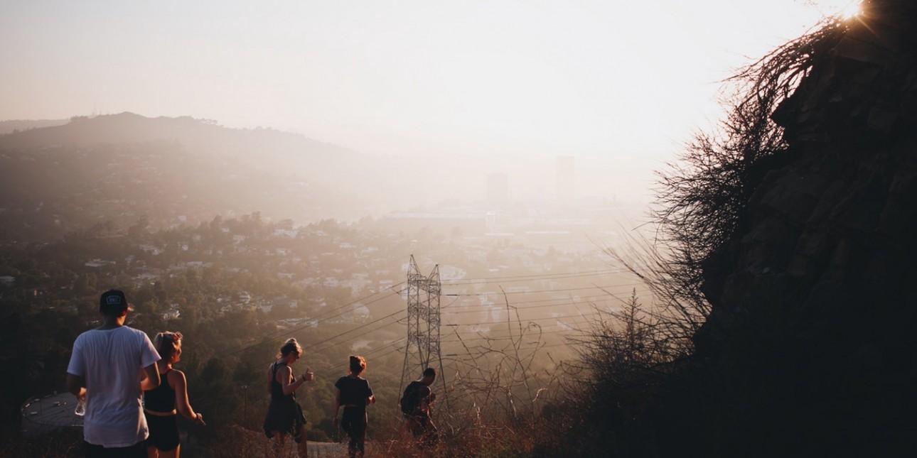 people walking down side of hill