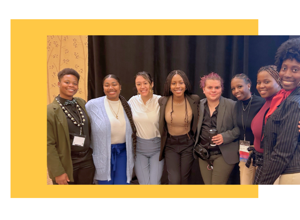 A group of young people smiling at a conference