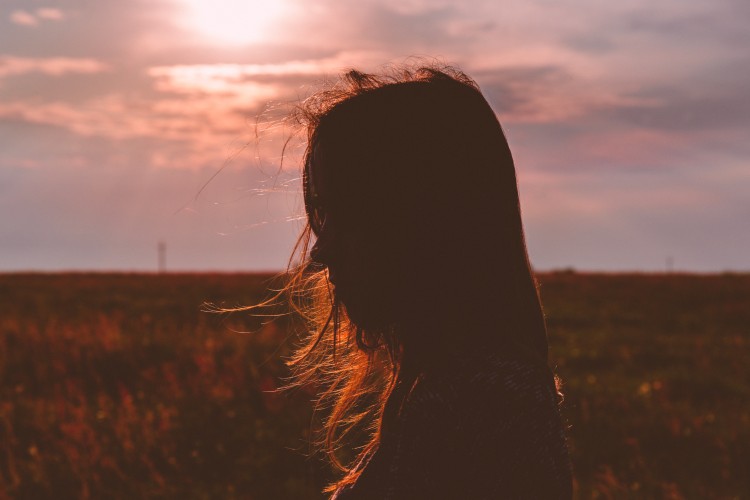 Silhouette of a person standing in the sun