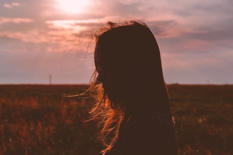 Silhouette of a person standing in the sun