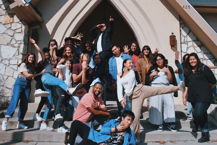 Young people posing in front of a building