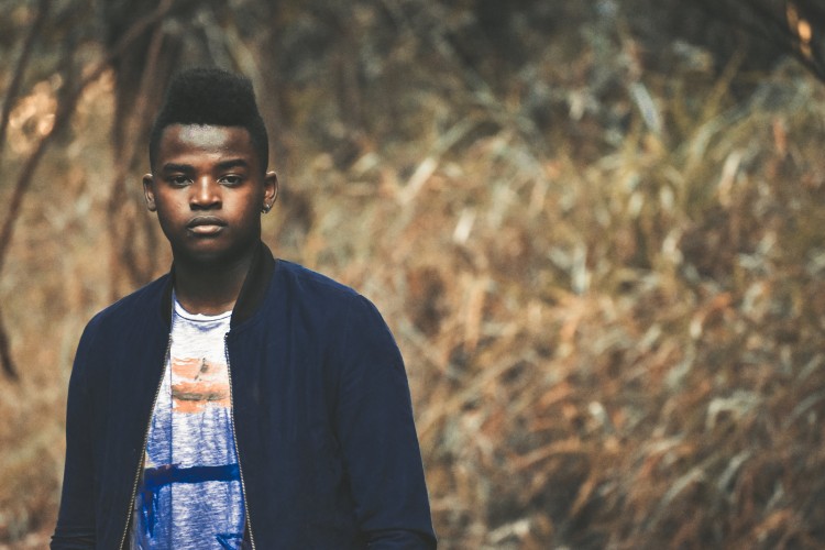 Young person standing in a meadow