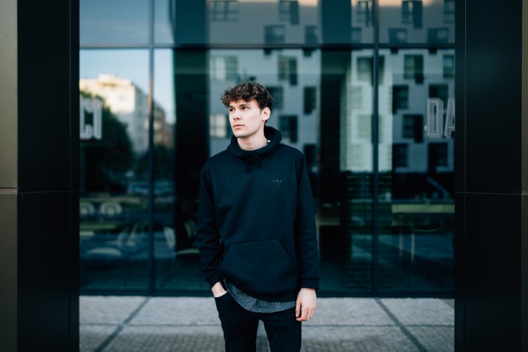 person standing by glass building