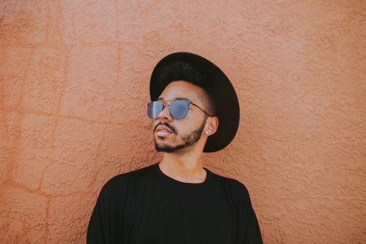 young person wearing hat and sunglasses