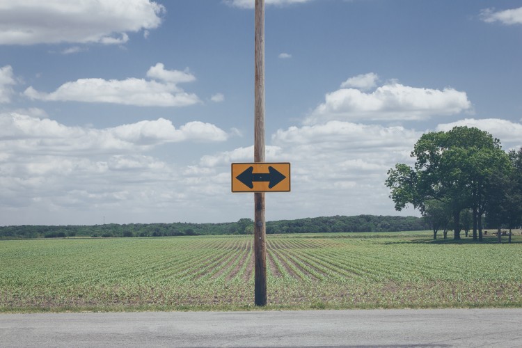 rural street sign with arrows