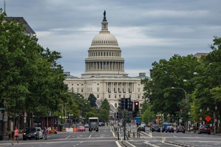 A view down a busy Washington, DC street toward the Capitol