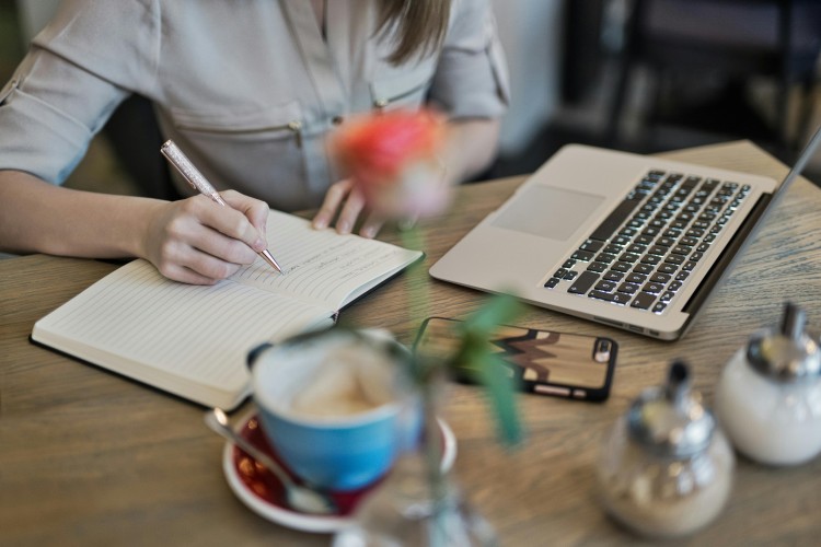 A woman taking notes from her laptop