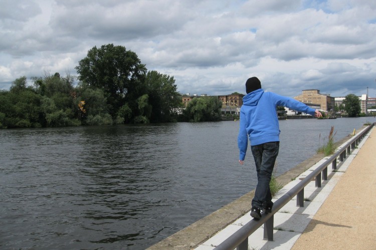 Boy walking near a river